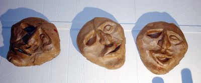 Three versions of a papier mache mask, by Eric Keast; Broken Vulture Art.