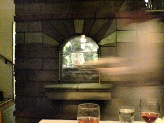 photograph: picture looking through an internal window into the kitchen at Zuni