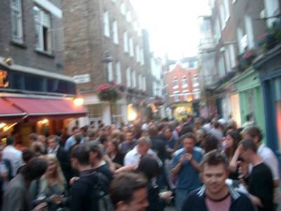 photograph picture of a load of friday night boozers standing outside the white horse on Newburgh Street in Soho London