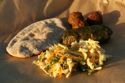 photograph picture of a vegan picnic of falafel, dolmades, homemade pitta and coleslaw with recipe links