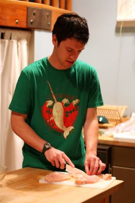 photograph picture of Tim learning to cook chicken tikka masala cutting the chicken