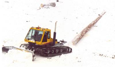 A Bombardier Snowcat towing a log