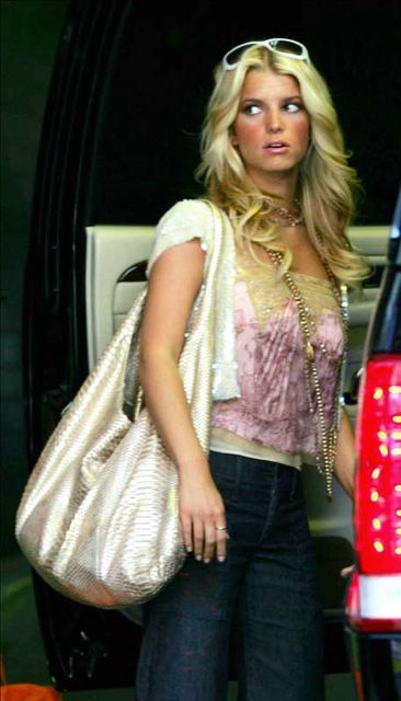 ... is leaving her hotel in New York carrying a large hobo metallic bag