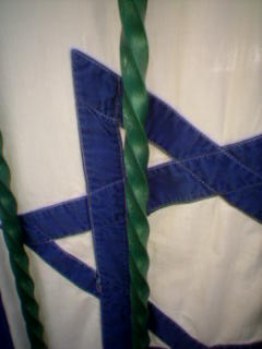 Detail of cotton Israeli flag with stitched-on Stars of David