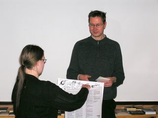 Saija Silvennoinen presenting the Finncon board game to Erkka Leppänen