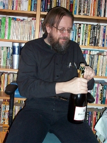Juhani opening a bottle of wine