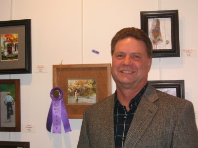 Roland Lee with Best of Show painting of fisherman at Virgin Valley Artists Lucky 13 International Small Works Competition
