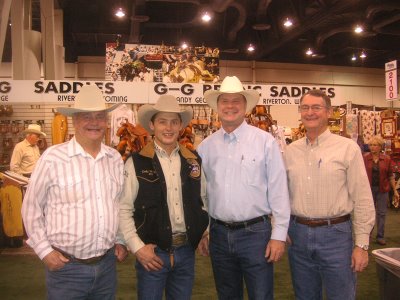 Photo of Roland Lee with cowboy Cody Wright, Lyman Hafen, and kelton Hafen at the National Finals Rodeo in 2006