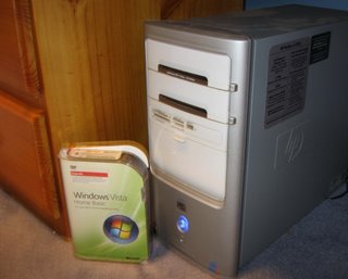 Windows Vista Home Basic kit next to HP Pavilion desktop computer