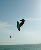 A kitesurfer soars through the air