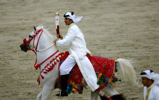The Asian Games Torch being carried at a gallop across Bahrain