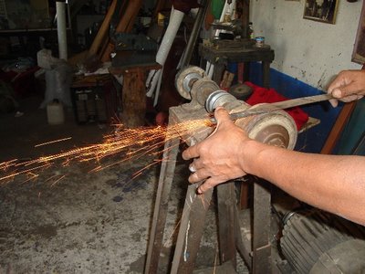 Mark in Mexico, http://markinmexico.blogspot.com/ Pale Horse Galleries for gifts, collectibles, Mexican arts and crafts, http://palehorsemex.vstore.com/ palehorsemex.blogspot.com/ Angel Aguilar pictured doing the first grinding on a hand forged and tempered knife blade in Ocotlan, Oaxaca, Mexico.