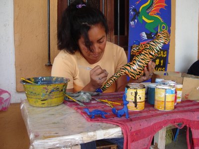 Pale Horse Galleries for Mexican arts and crafts. http//palehorsemex.vstore.ca/ Josefina Morales painting another creation, an alebrije leopard, by Zapotec wood carver Oscar Carrillo.