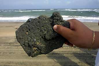 For gifts, collectibles and Mexican art and crafts, visit Pale Horse Galleries online store. http://palehorsemex.vstore.ca/ A worker holds up a piece of asphalt collected from a Tabasco beach which PEMEX claims is naturally occurring.