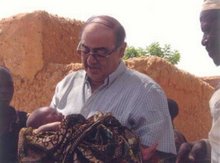 José Collado sosteniendo a un recien nacido en Níger