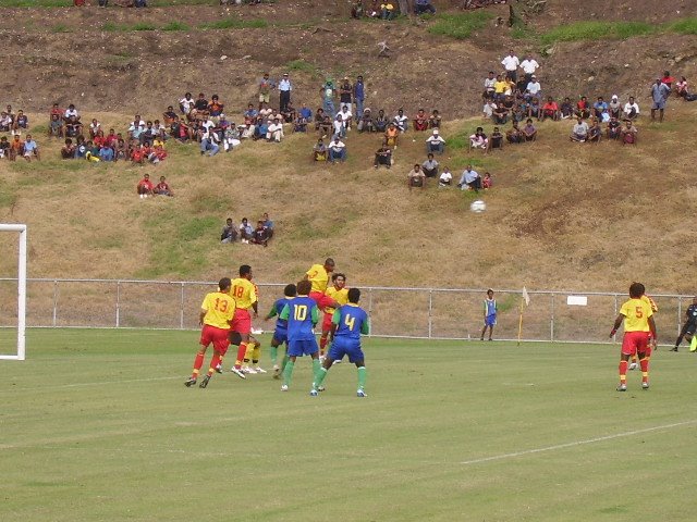 ONE PNG DEFENDER HEADING THE BALL AWAY FROM SI PLAYERS